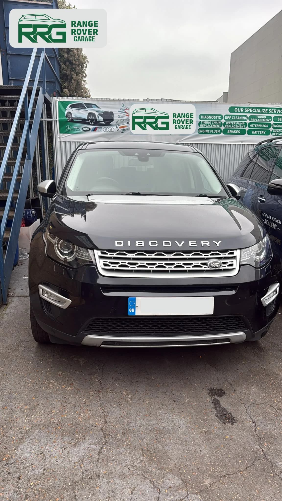 Black Range Rover parked outside the workshop