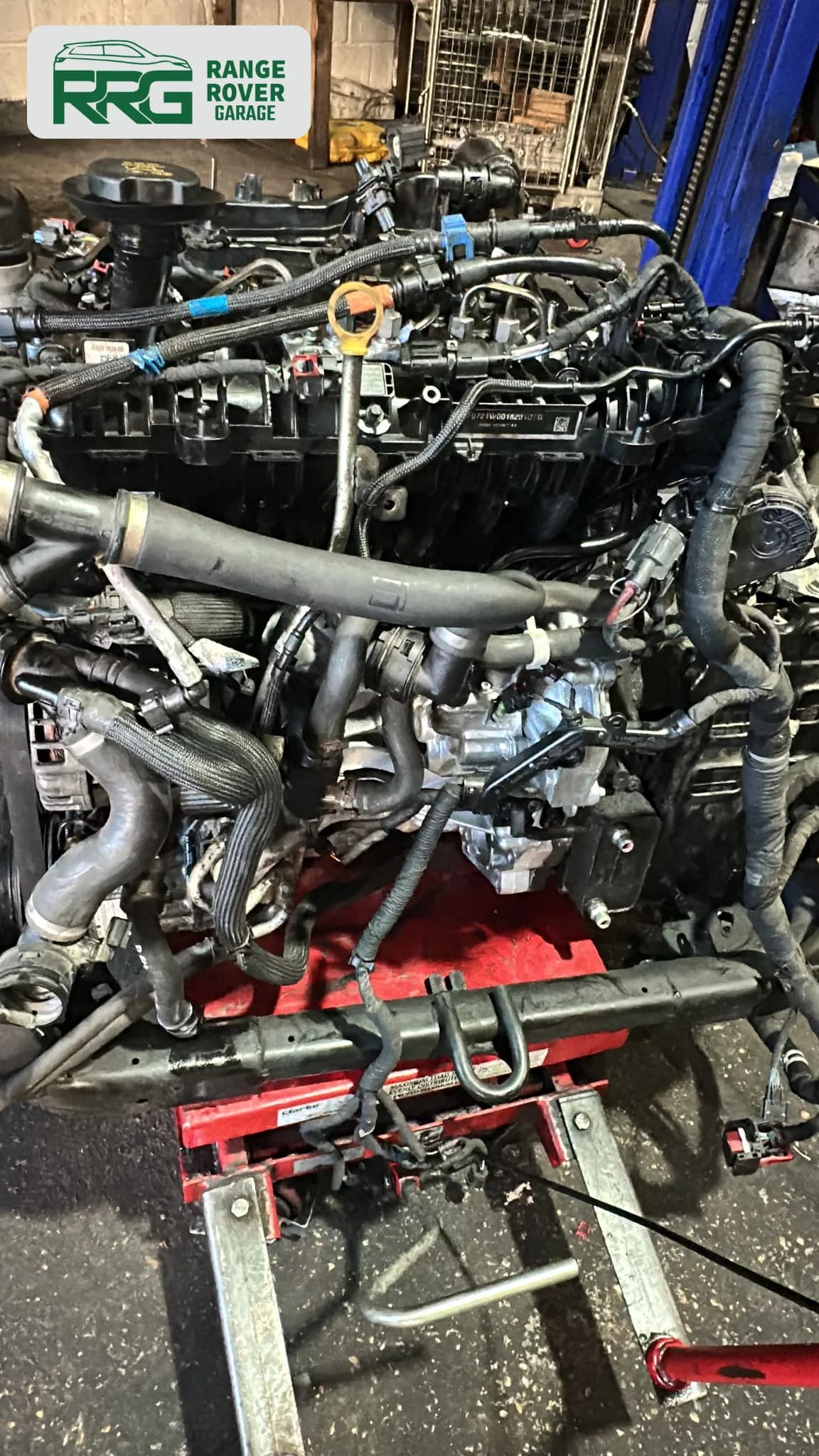 Engine and hoses supported by a red workshop stand