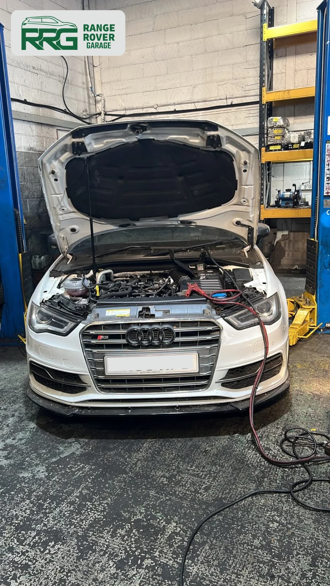 White Range Rover Evoque with its bonnet open in the workshop
