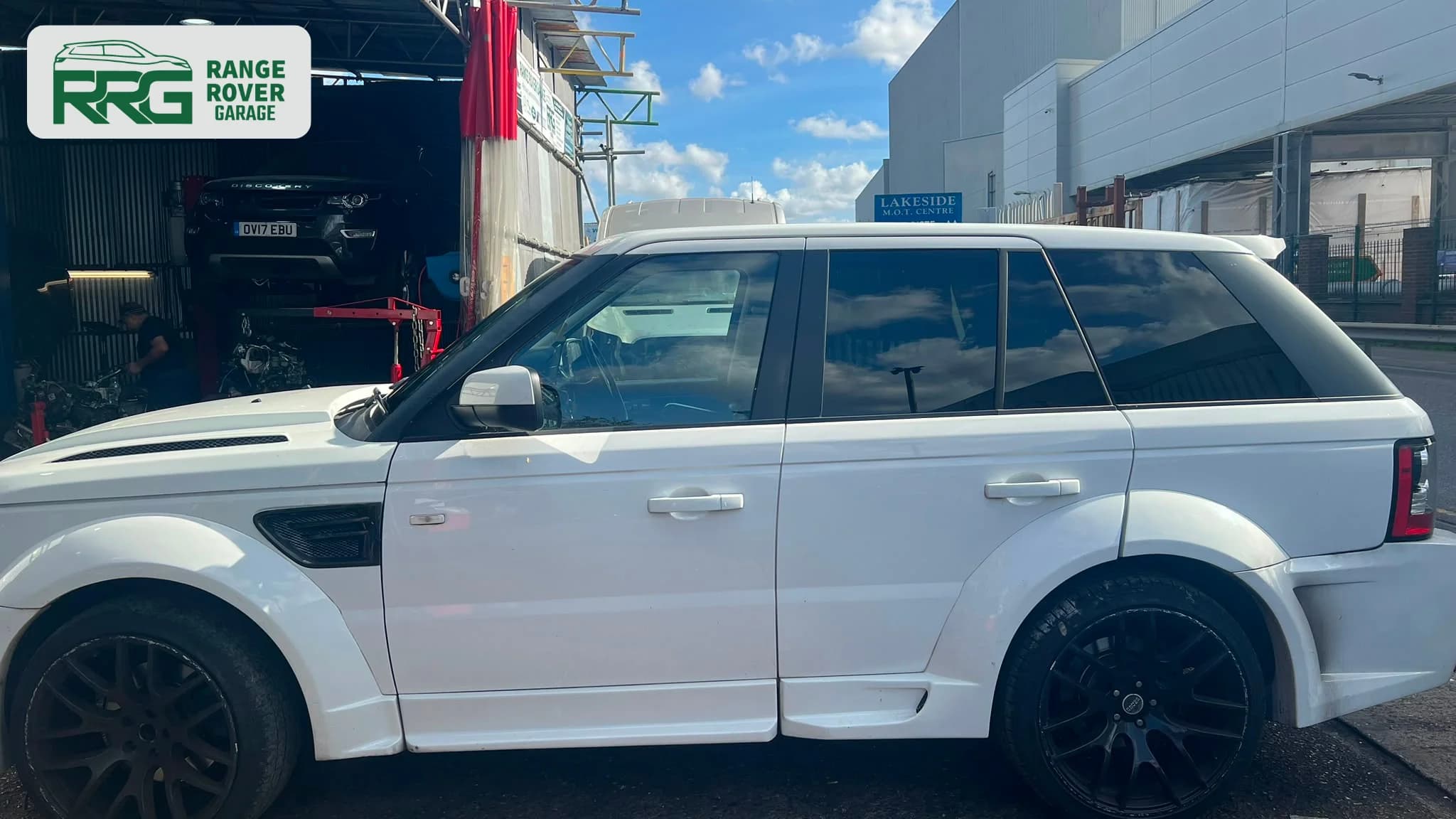 White Range Rover in profile outside Range Rover Garage