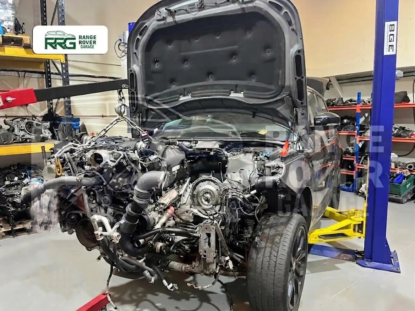Removed engine and drivetrain in front of a Range Rover
