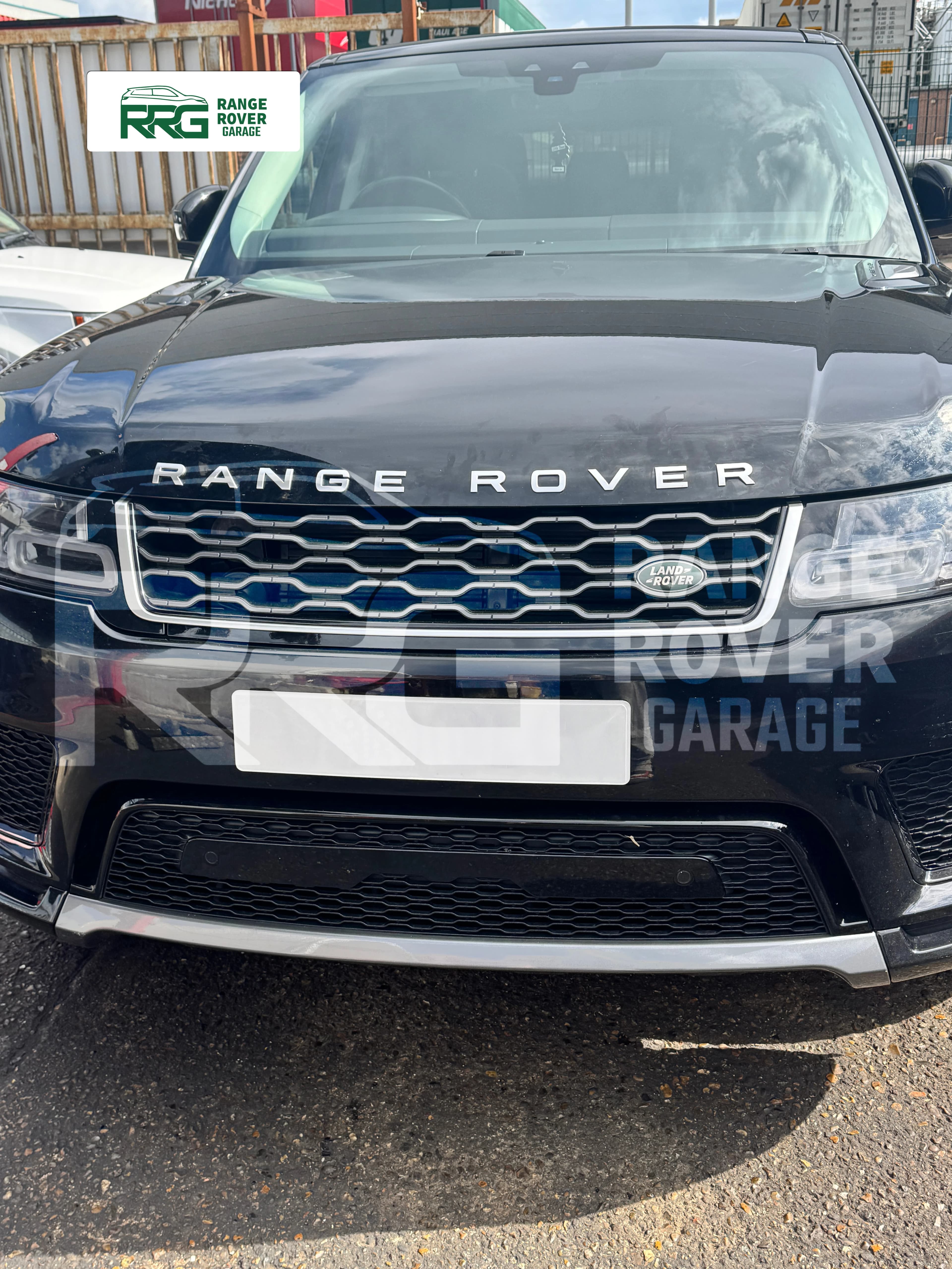 Front view of a Range Rover parked outside the workshop