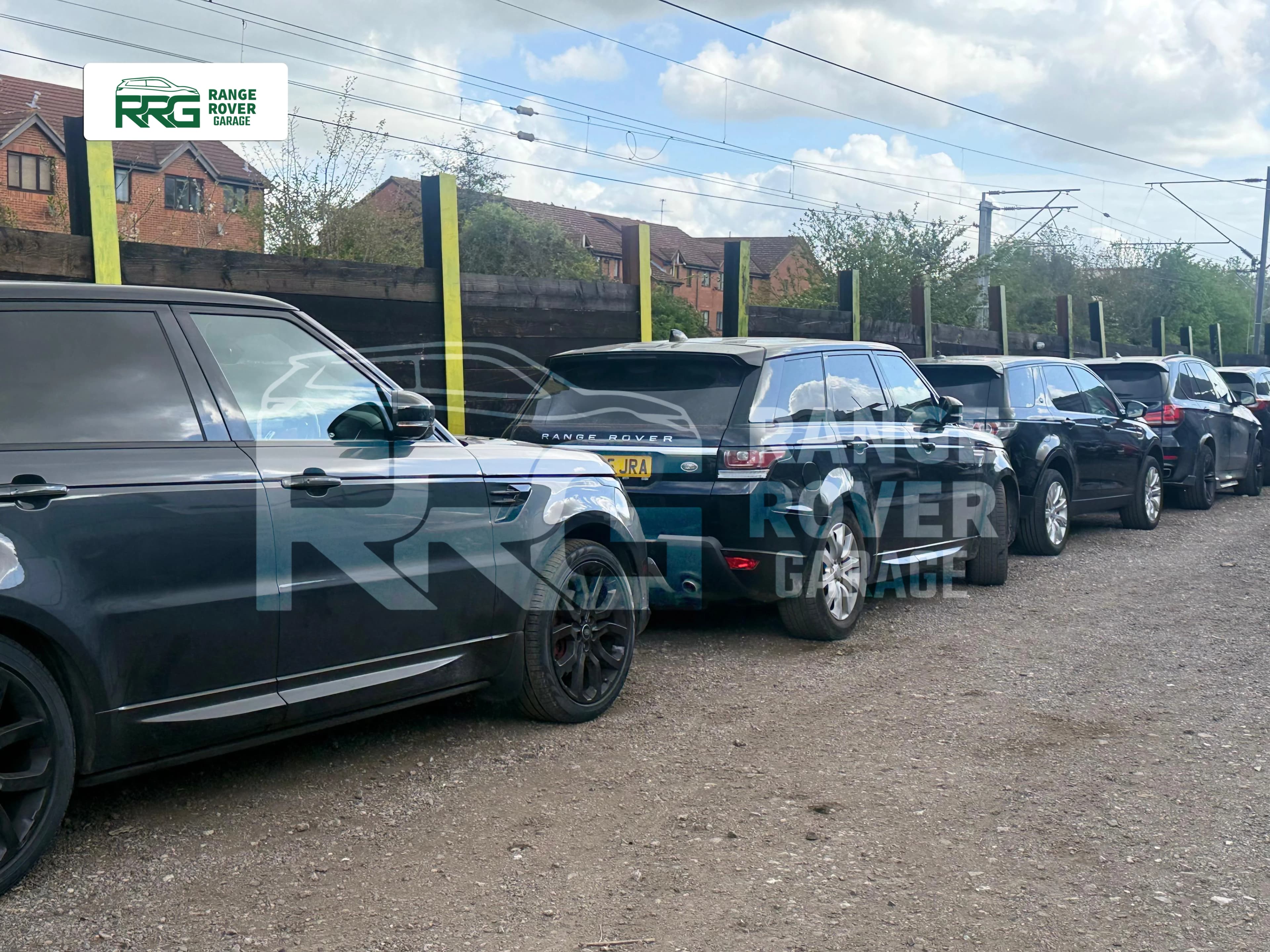 Range Rover and Land Rover vehicles lined up outside the workshop